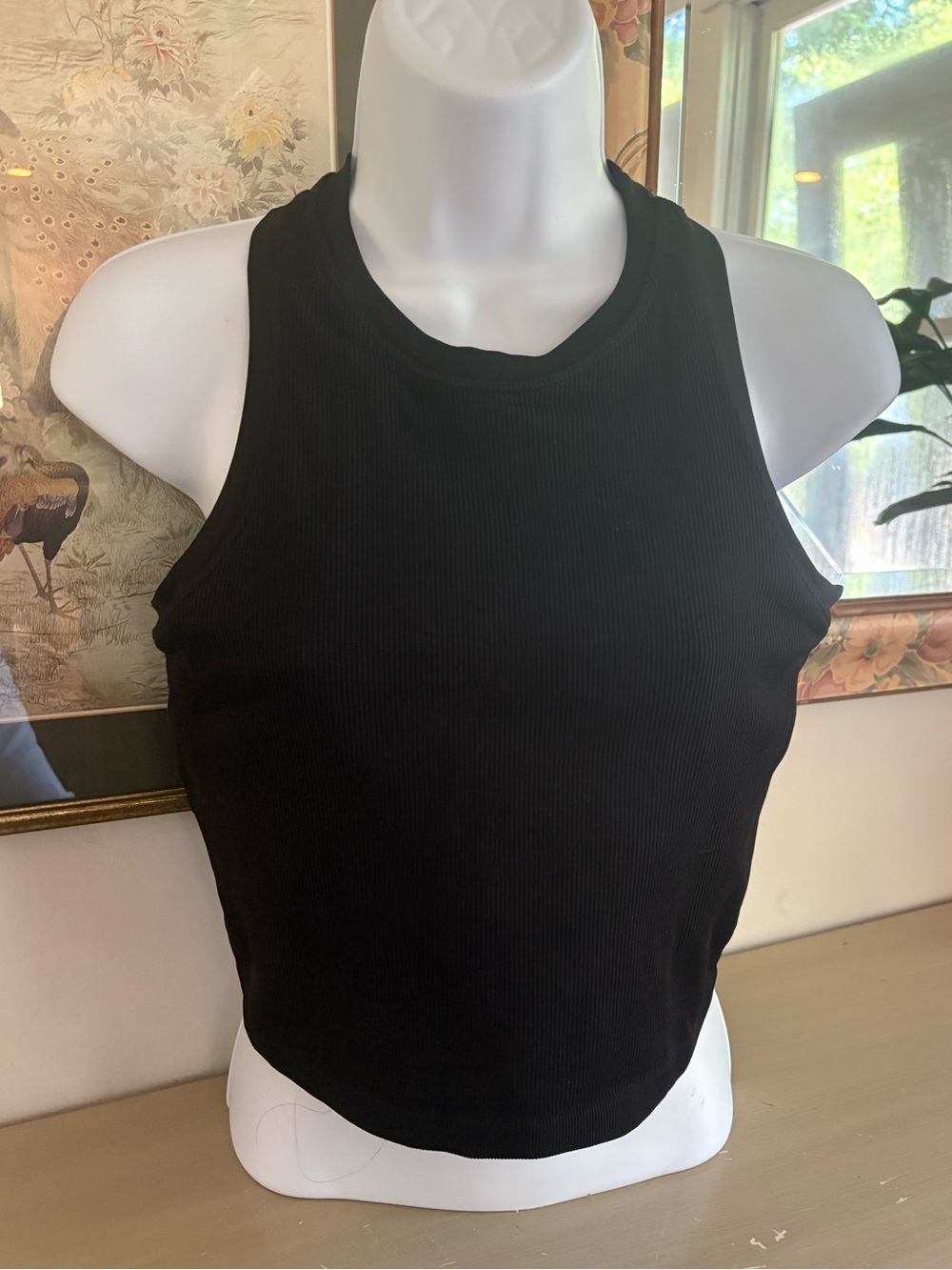 Pro-fit black ribbed tank top with a high neck design, built in bra